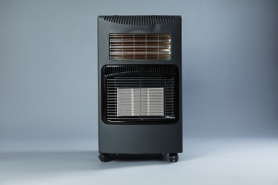 Photo of One electric heater on grey background. Domestic appliance