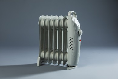 Photo of One electric heater on grey background. Domestic appliance
