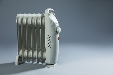 Photo of One electric heater on grey background. Space for text