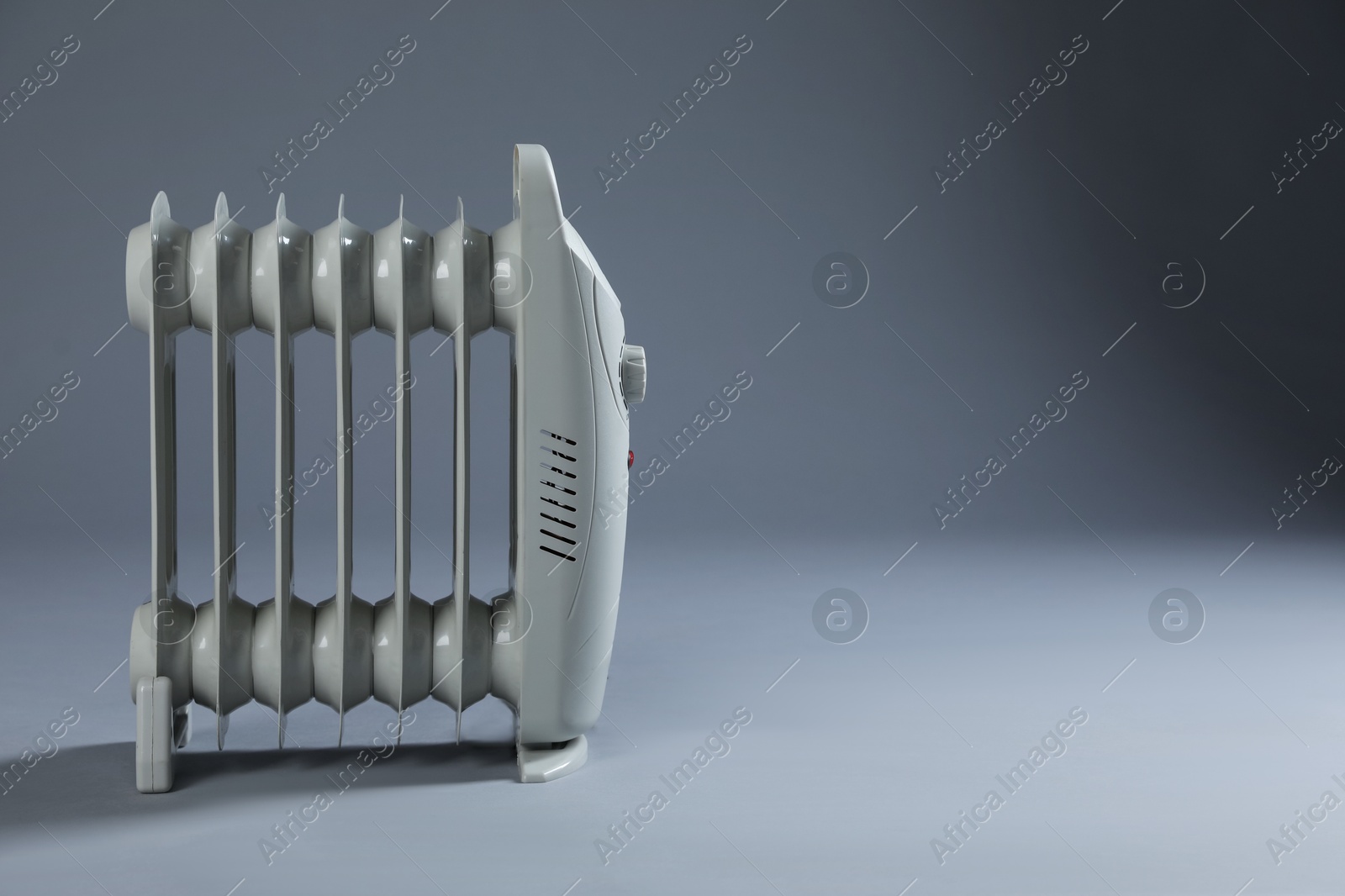 Photo of One electric heater on grey background. Space for text