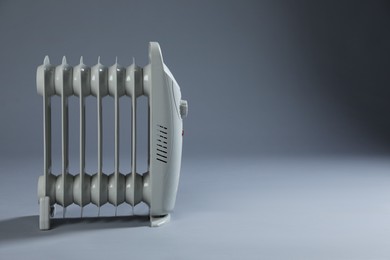 Photo of One electric heater on grey background. Space for text