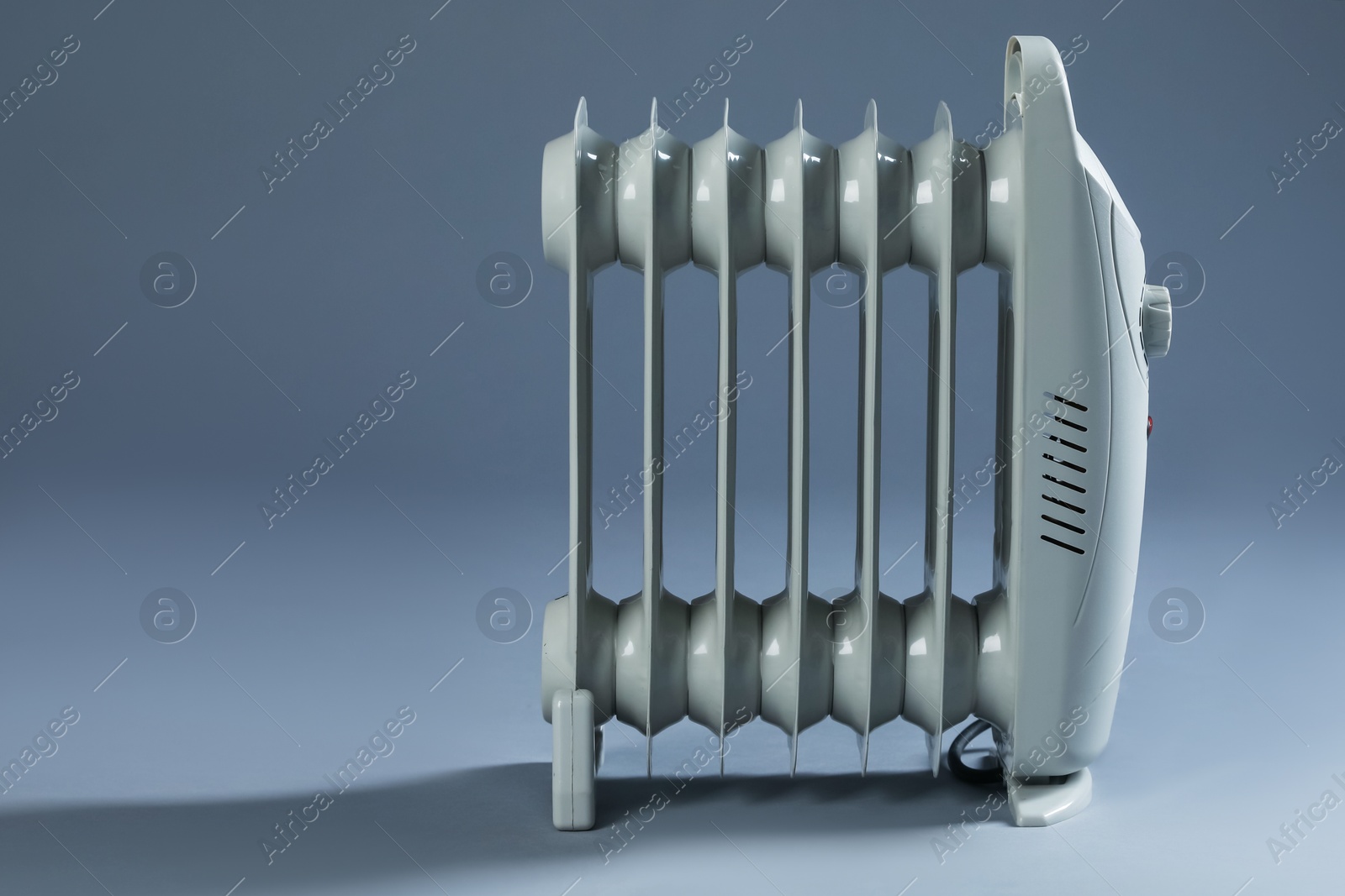Photo of One electric heater on grey background. Space for text