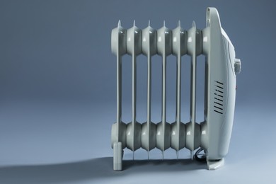 Photo of One electric heater on grey background. Space for text