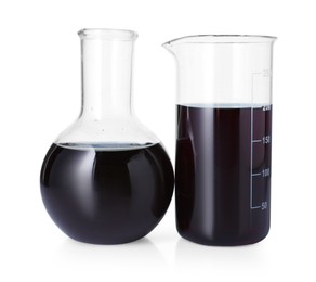 Photo of Different laboratory glassware with black liquid isolated on white