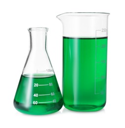 Photo of Different laboratory glassware with green liquid isolated on white