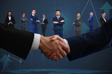Image of Partners shaking hands against business people. Graph on background