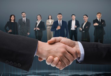 Image of Partners shaking hands against business people. Grey gradient background