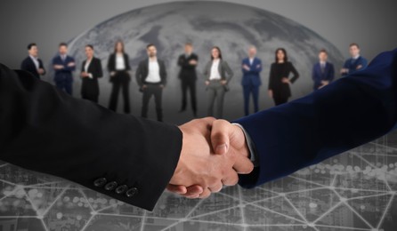 Image of Partners shaking hands against business people. Globe on background
