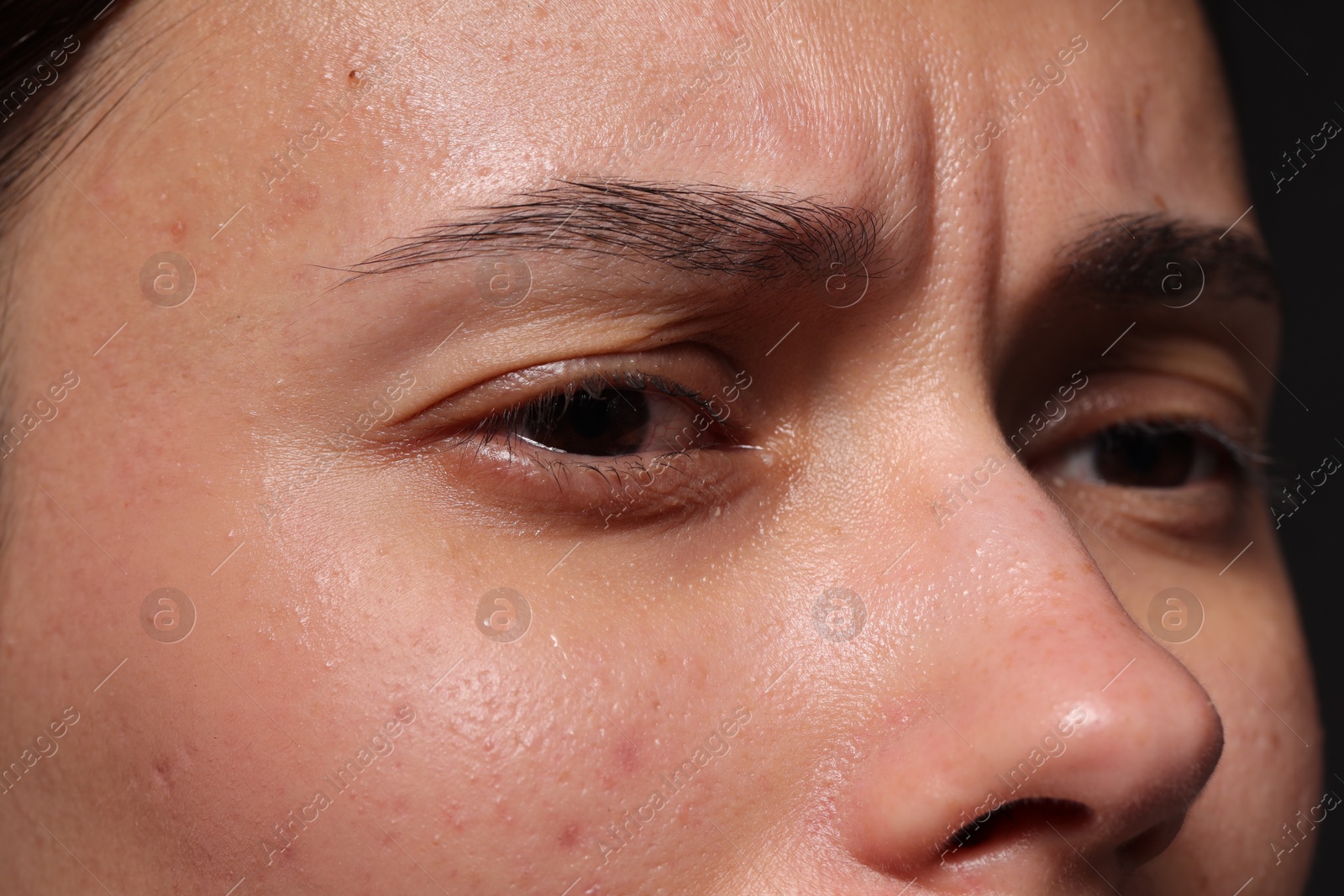 Photo of Closeup view of sad young woman crying