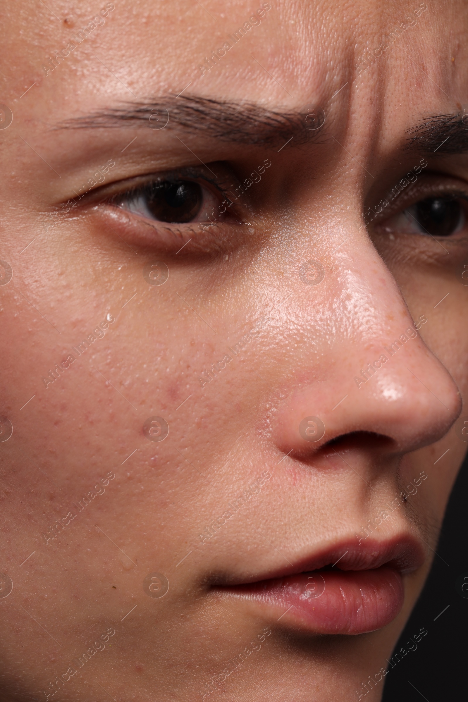 Photo of Closeup view of sad young woman crying