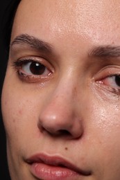 Photo of Closeup view of sad young woman crying