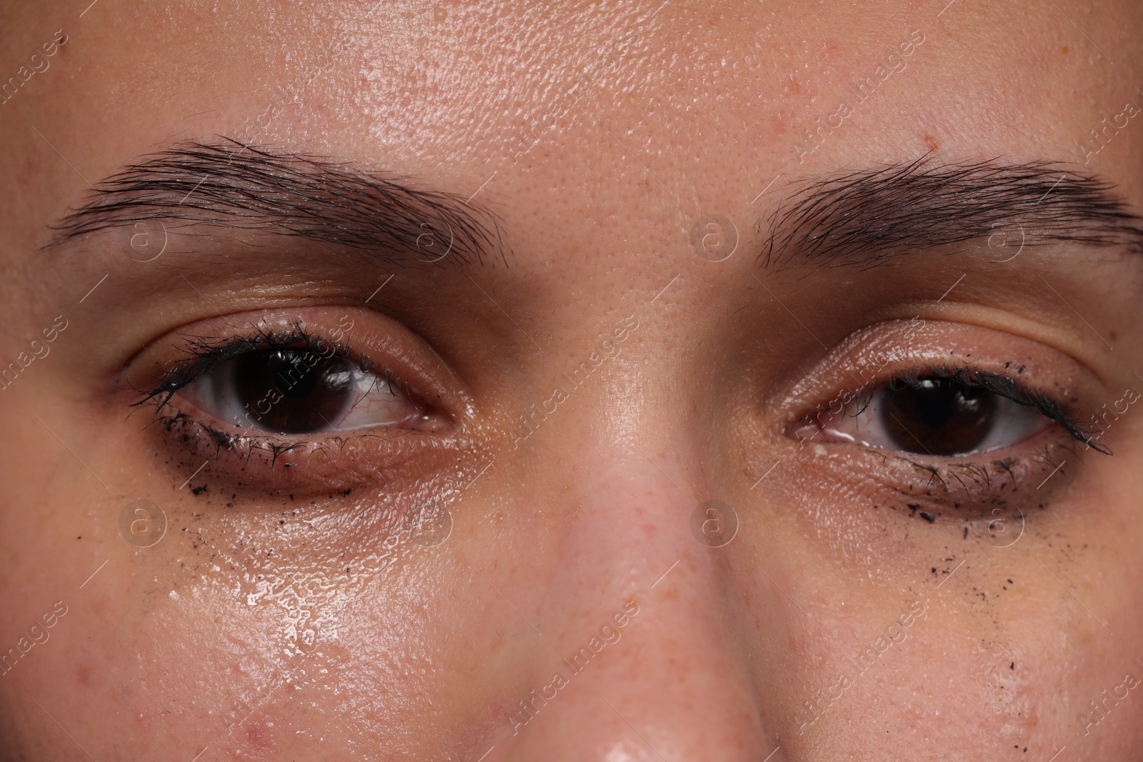 Photo of Closeup view of sad young woman crying