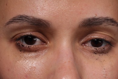 Photo of Closeup view of sad young woman crying