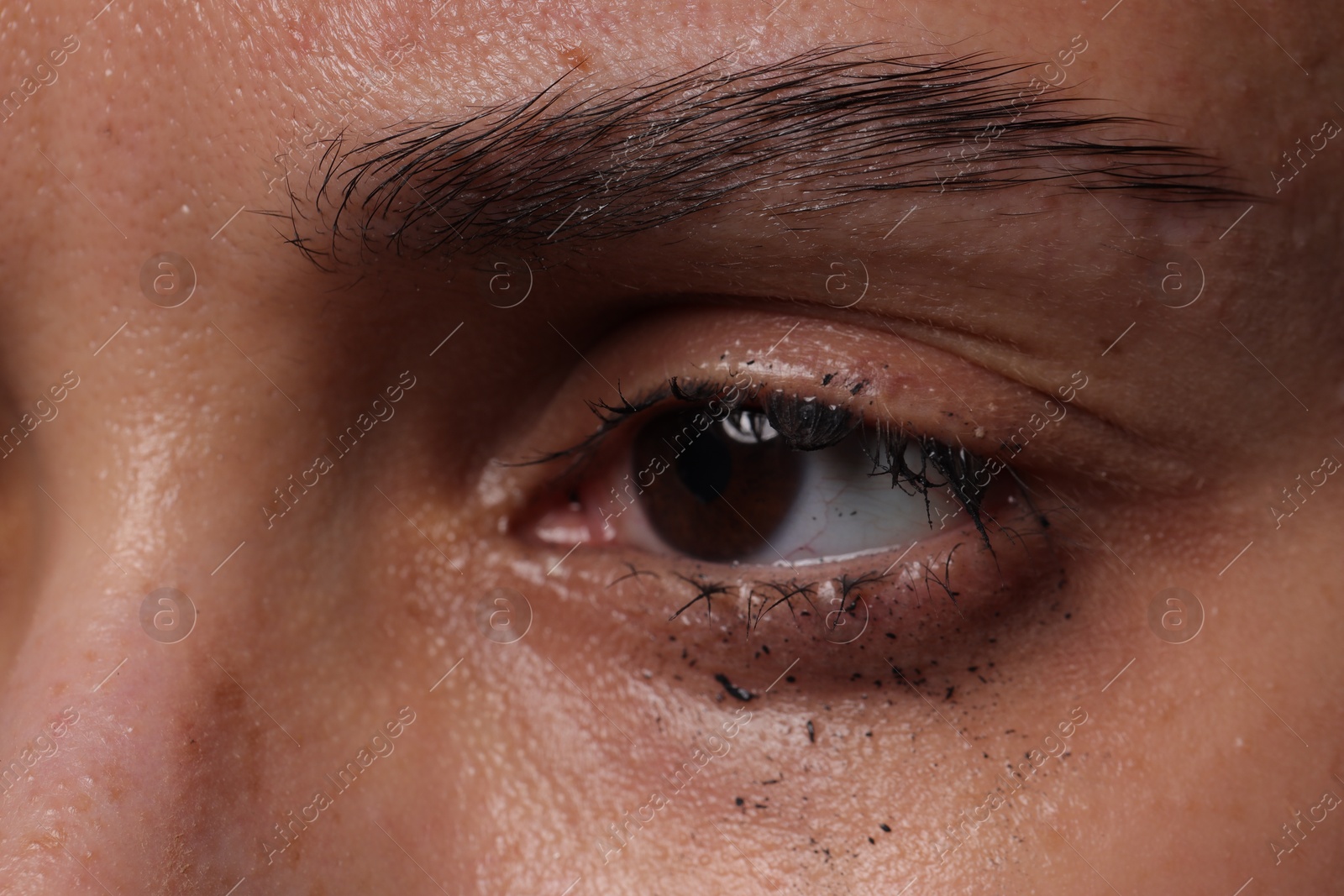 Photo of Closeup view of sad young woman crying