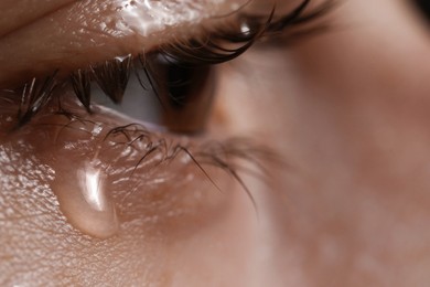 Photo of Closeup view of sad woman crying, space for text