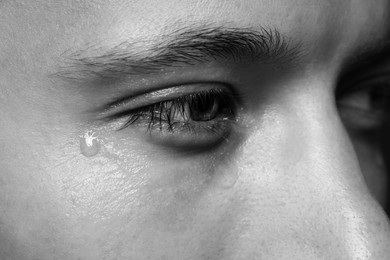 Photo of Closeup view of sad man crying. Black and white effect