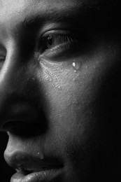 Photo of Closeup view of sad man crying. Black and white effect