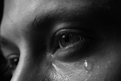 Photo of Closeup view of sad man crying. Black and white effect