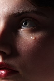 Photo of Closeup view of sad young woman crying