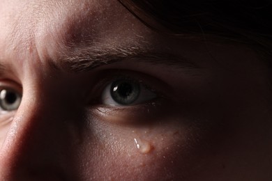Photo of Closeup view of sad young woman crying