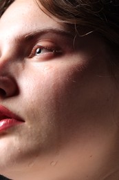 Photo of Closeup view of sad young woman crying