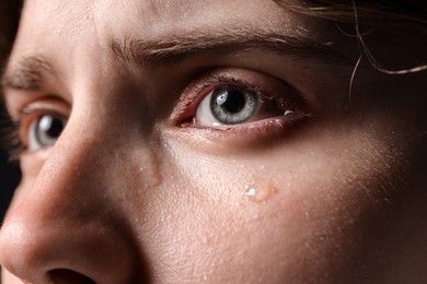 Photo of Closeup view of sad young woman crying
