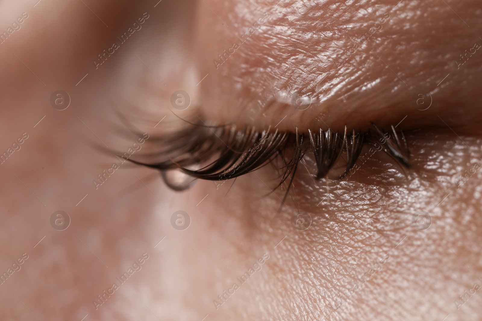 Photo of Closeup view of sad young woman crying