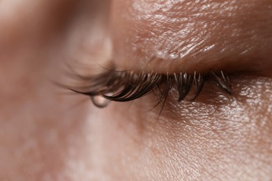 Photo of Closeup view of sad young woman crying