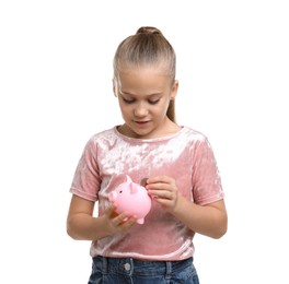 Photo of Little girl putting her pocket money into piggy bank on white background