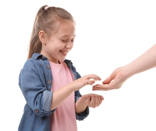Photo of Mother giving her daughter pocket money on white background, closeup
