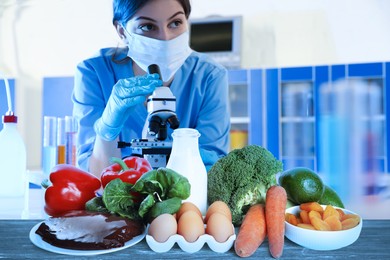 Image of Food analysis. Laboratory worker examining samples of fresh products