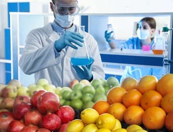 Image of Food analysis. Laboratory workers examining samples of fresh products