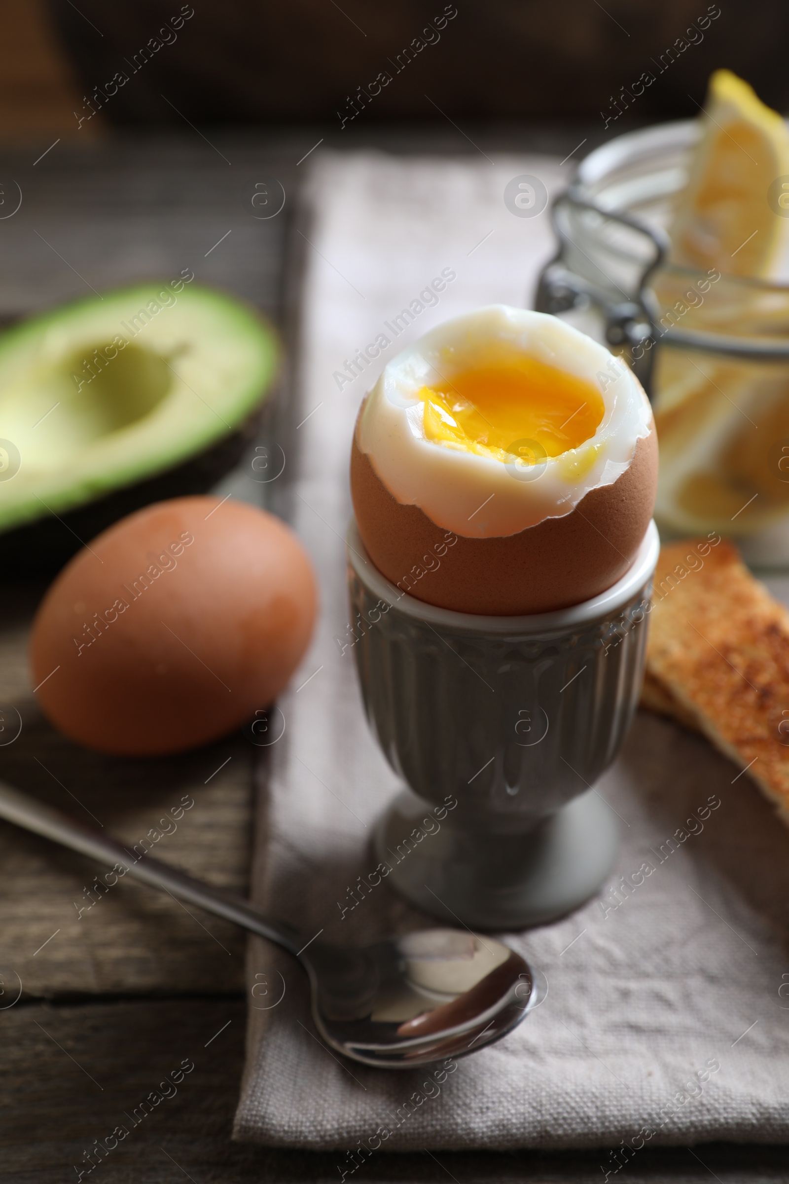 Photo of Soft boiled egg served for breakfast on wooden table