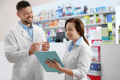 Image of Portrait of professional pharmacists in modern drugstore