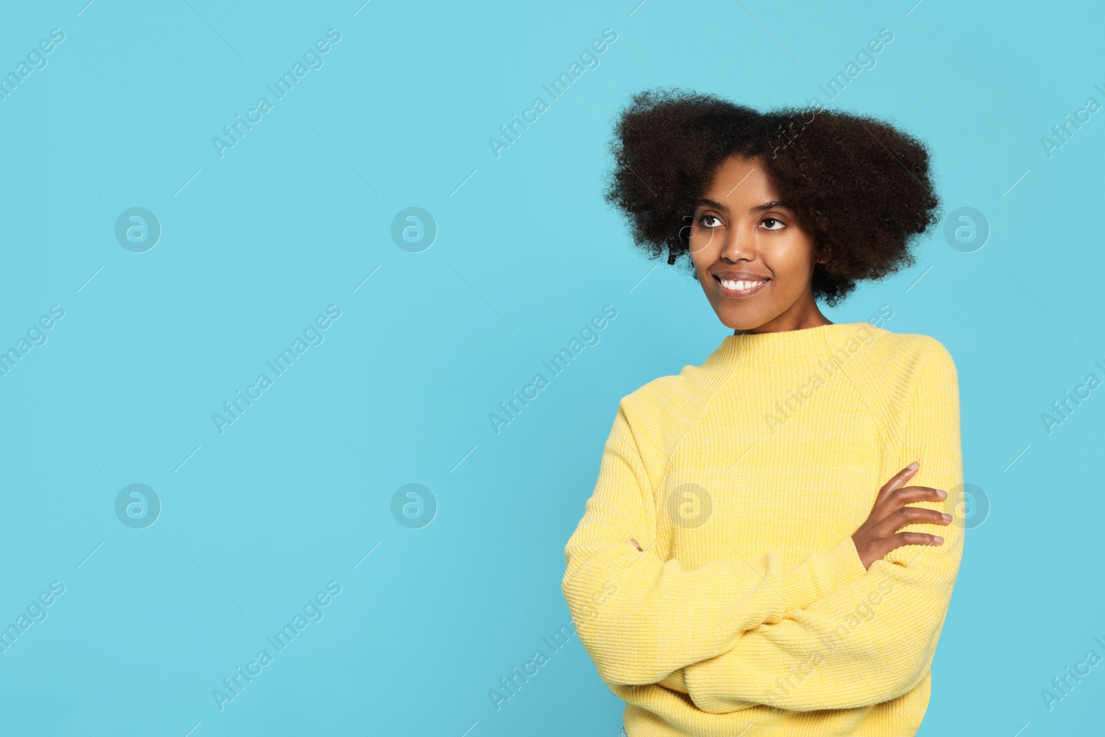 Photo of Portrait of smiling African American woman on light blue background. Space for text