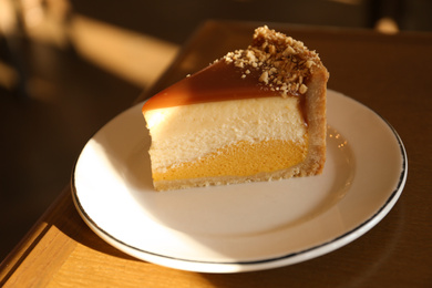 Piece of delicious cheesecake on table, closeup