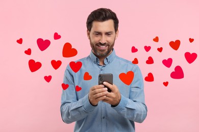 Long distance love. Man chatting with sweetheart via smartphone on pink background. Hearts flying out of device and swirling around him