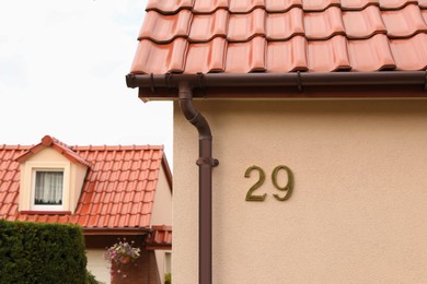 Number 29 on textured house wall outdoors