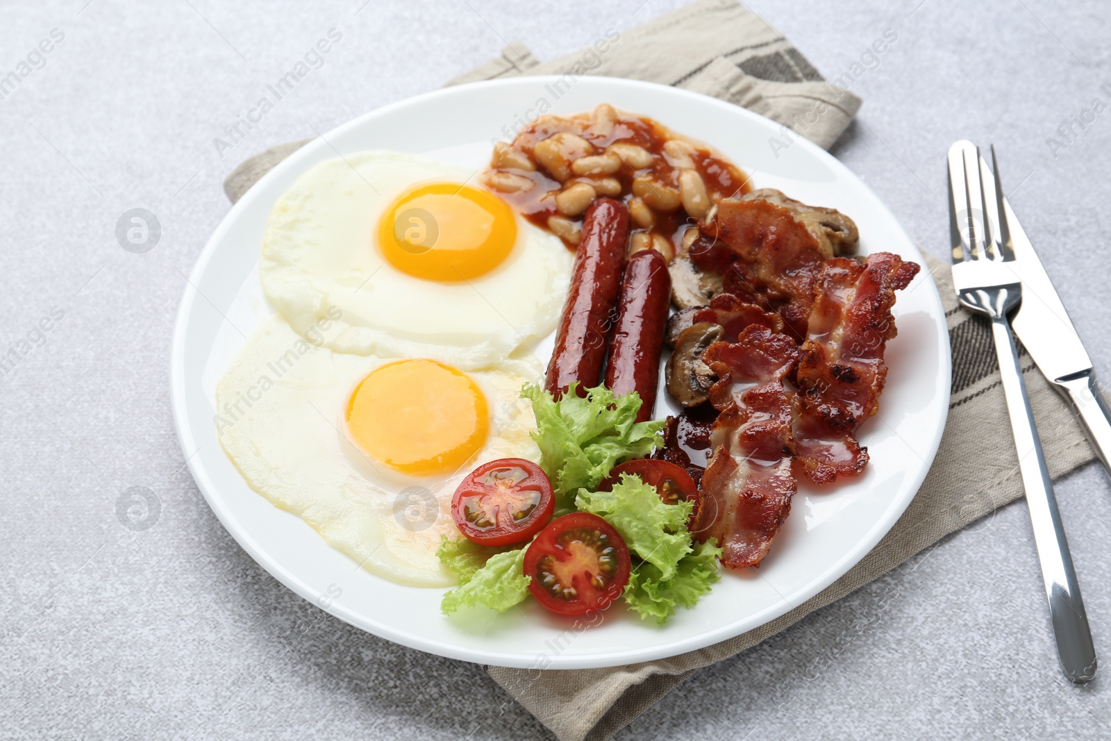 Photo of Delicious breakfast with sunny side up eggs on light table