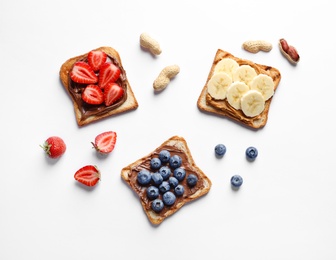 Photo of Tasty toast bread with banana, strawberry and blueberry on white background
