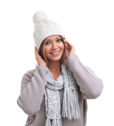 Photo of Young woman in warm sweater, scarf and hat on white background. Winter season