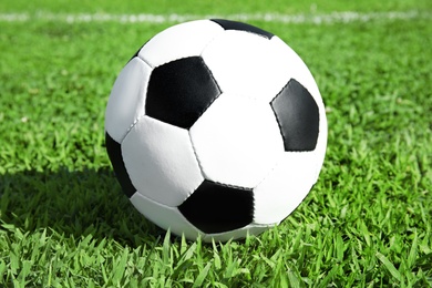Photo of Soccer ball on fresh green football field grass