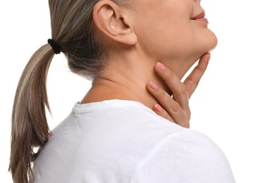 Mature woman touching her neck on white background, closeup