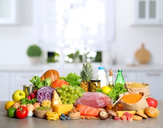 Image of Different products on wooden table in kitchen. Healthy food and balanced diet