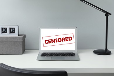 Image of Laptop with censorship sign on white table
