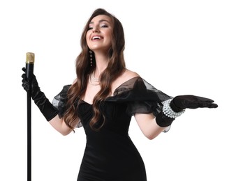 Beautiful young woman in stylish black dress with microphone singing on white background