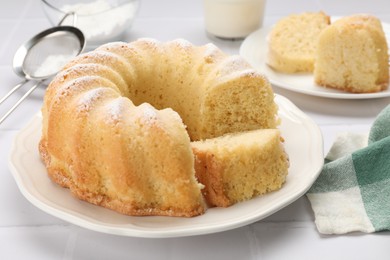 Photo of Delicious freshly baked sponge cake on white table, closeup