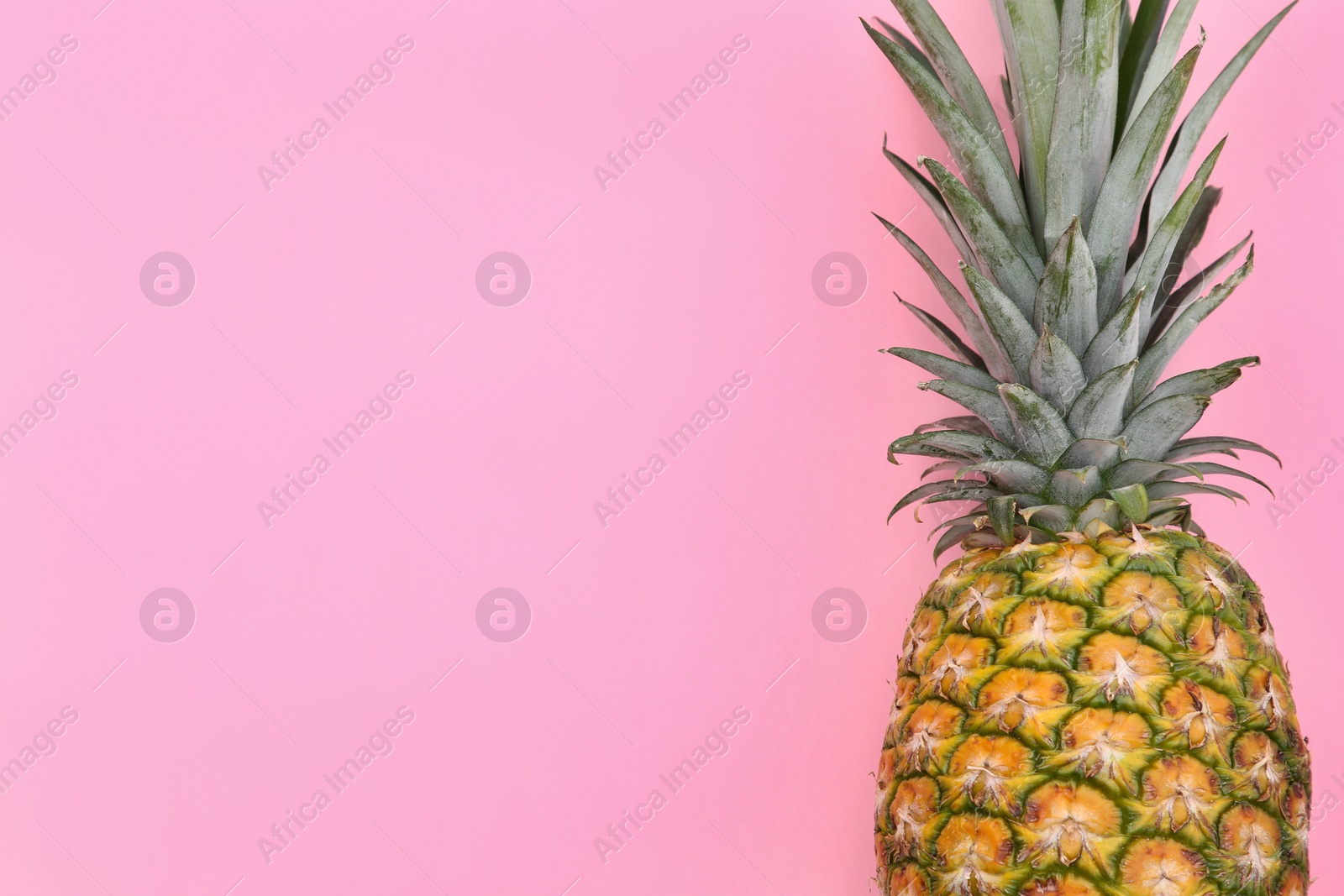 Photo of Delicious ripe pineapple on pink background, top view. Space for text