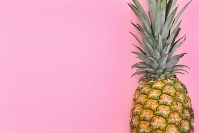 Delicious ripe pineapple on pink background, top view. Space for text