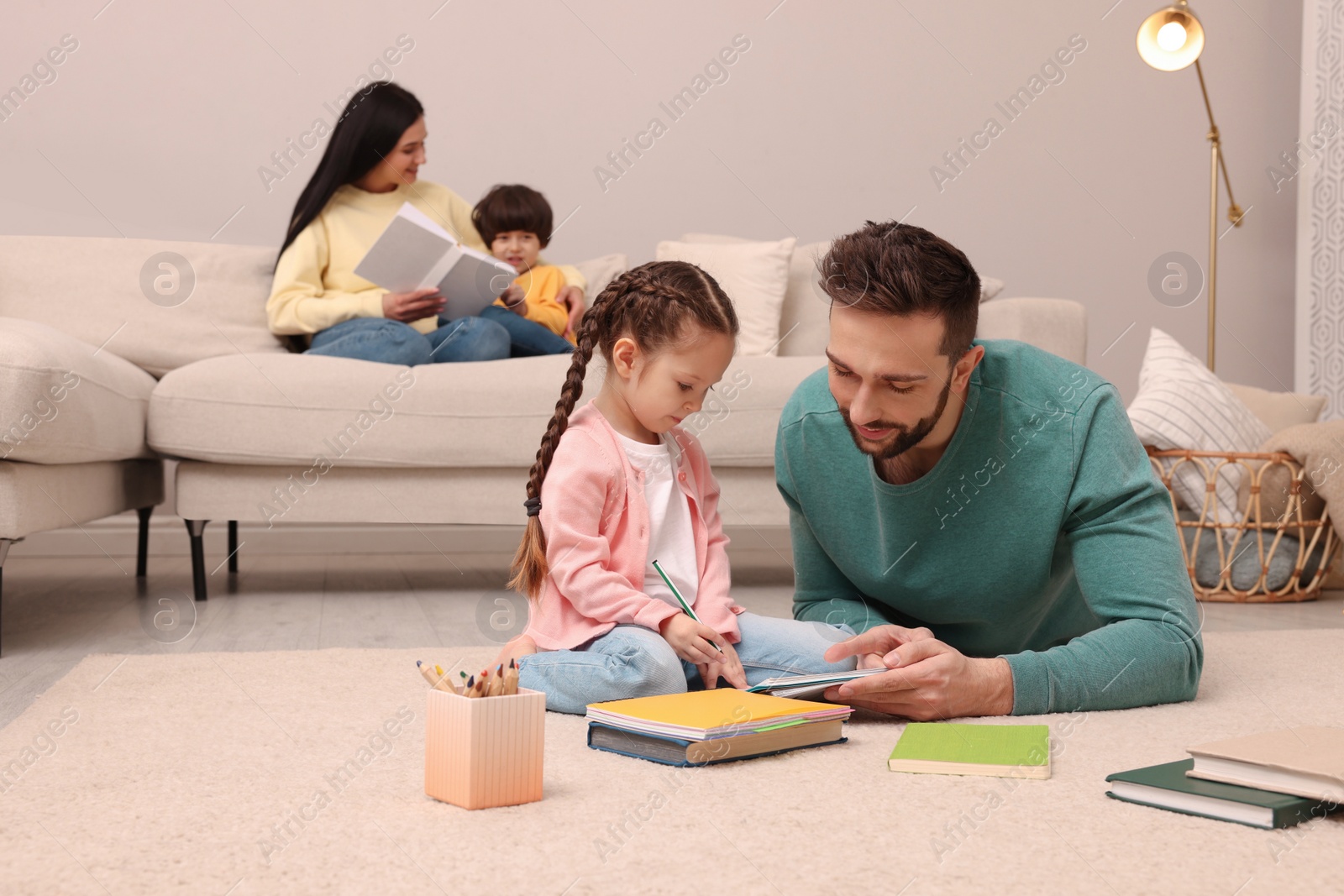 Photo of Happy family spending time together in living room